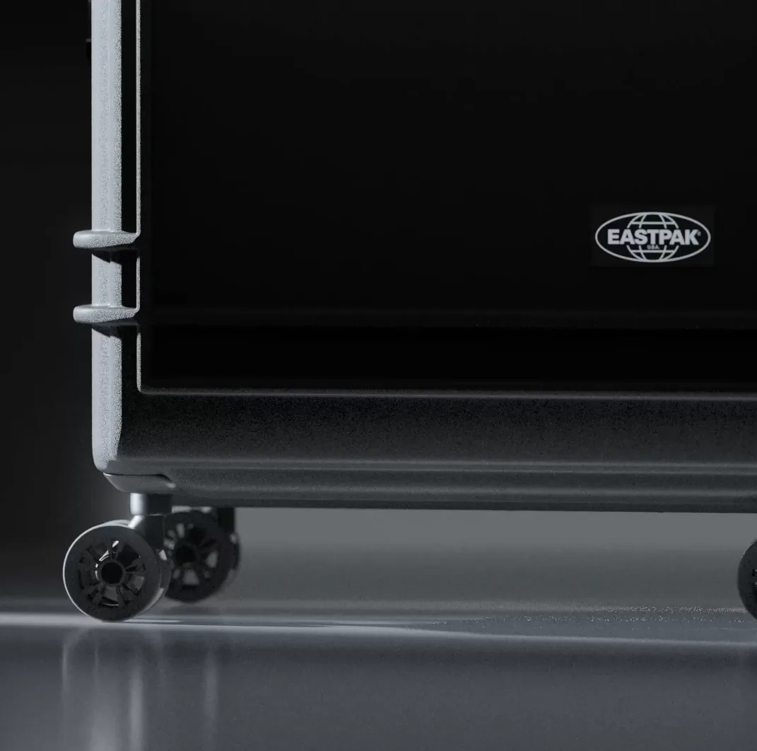 Close-up of the Resist'r case's corner, wheel, and logo badge